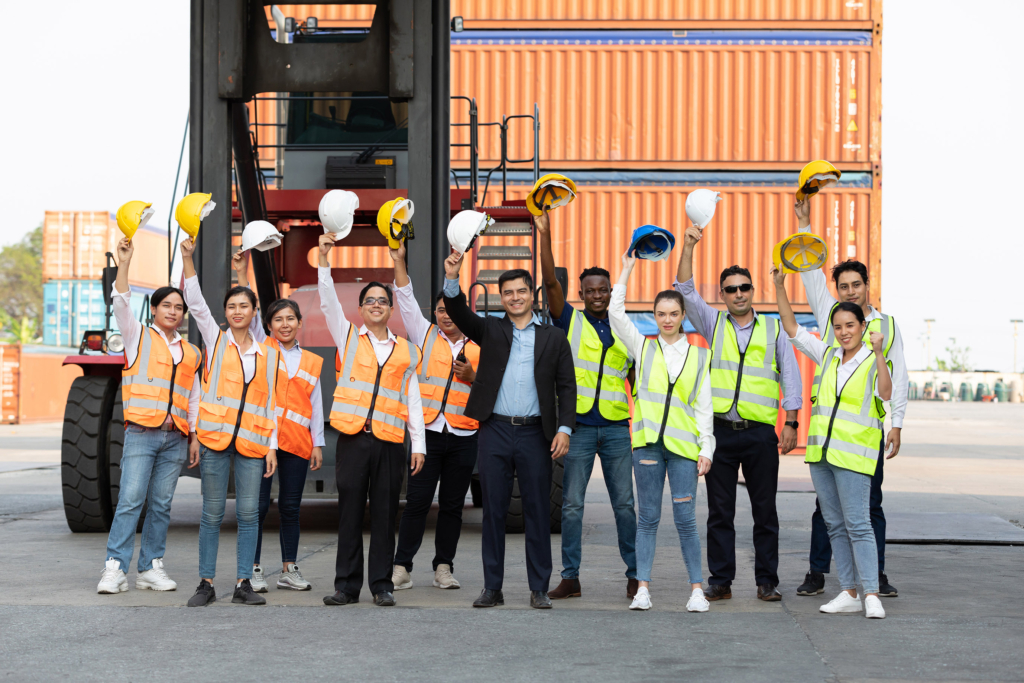 Happy Construction workers with their hard hats up in the air