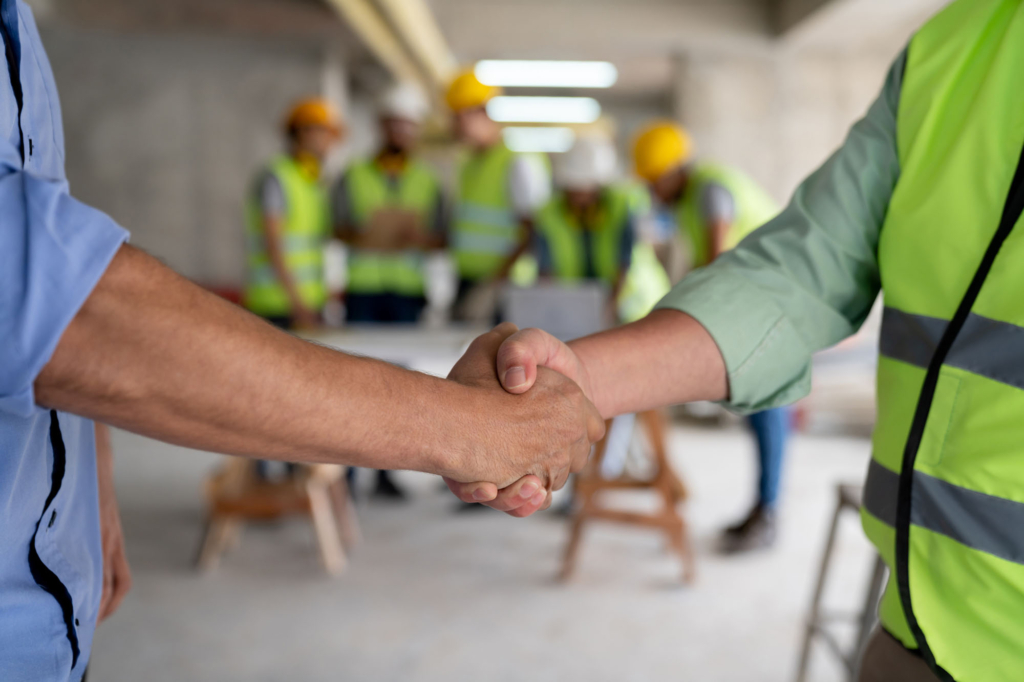 Builder and developer shaking hands at a commercial construction project in Sydney