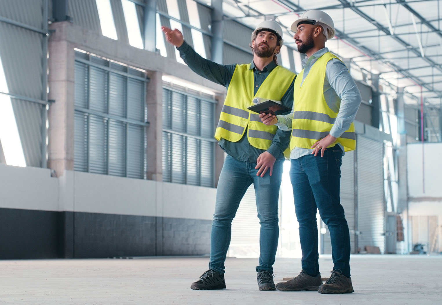 Commercial construction, 2 builders inspecting a warehouse construction project
