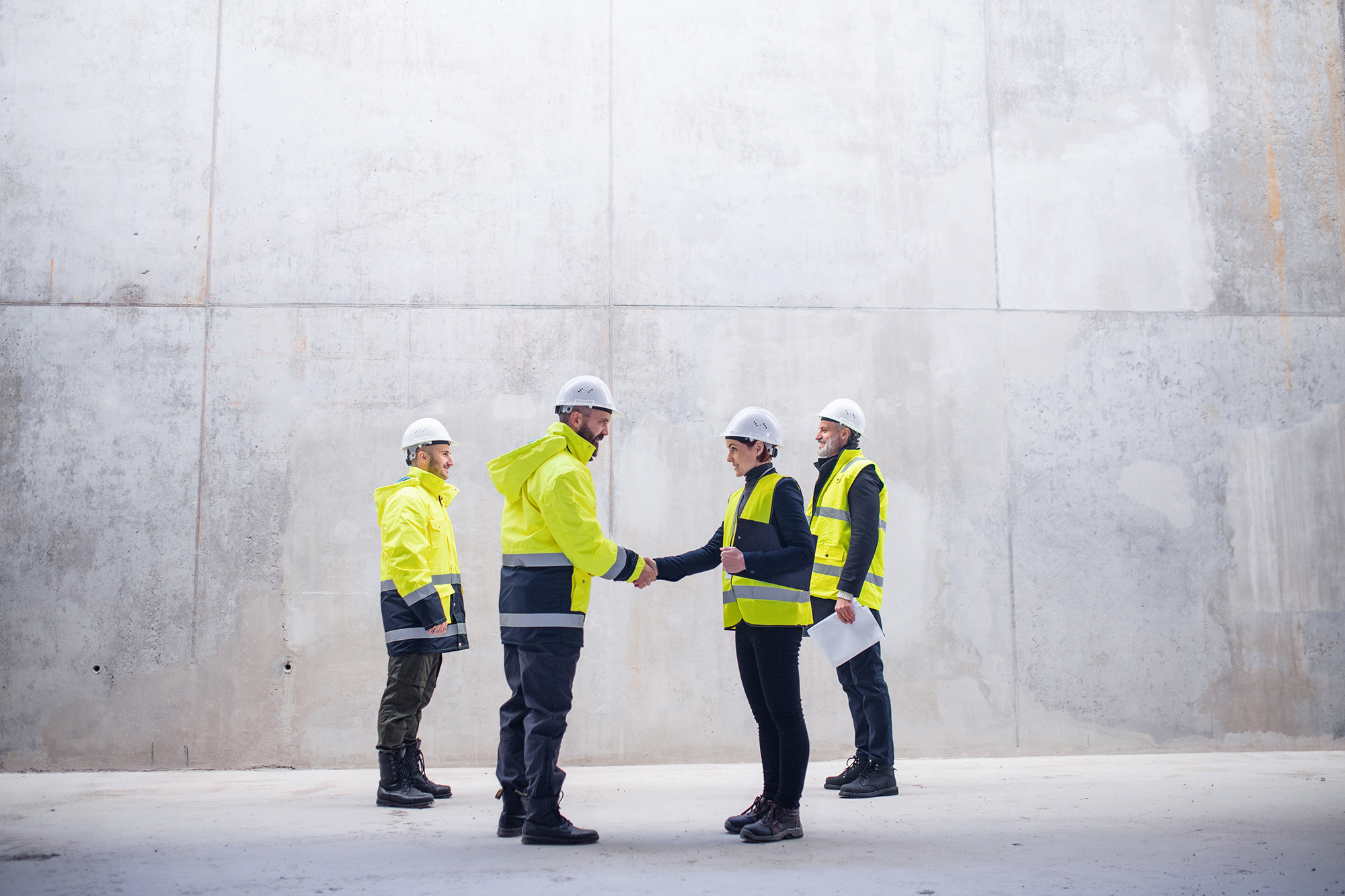 construction site managers shaking hands on site.